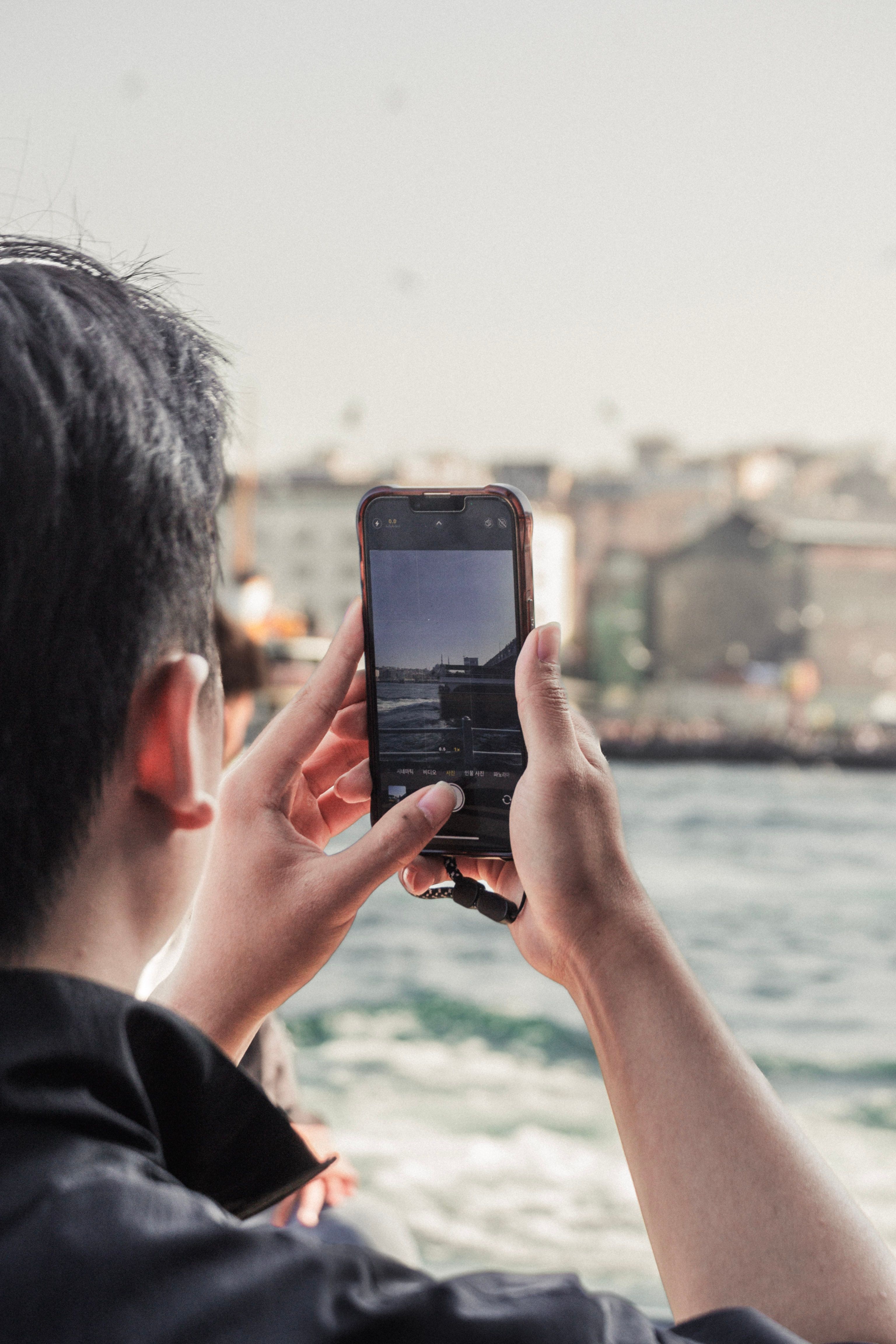 Capturing Waterfront View on Smartphone · Free Stock Photo