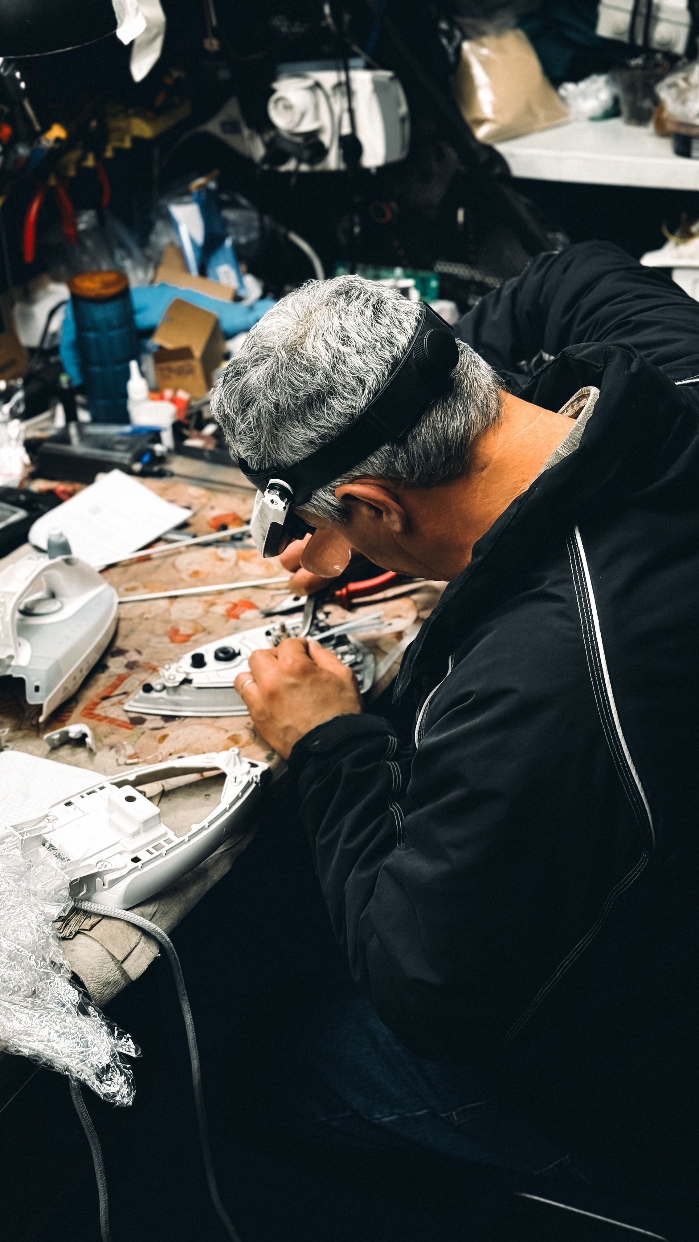 Skilled Technician Repairs Electronics in Workshop · Free Stock Photo