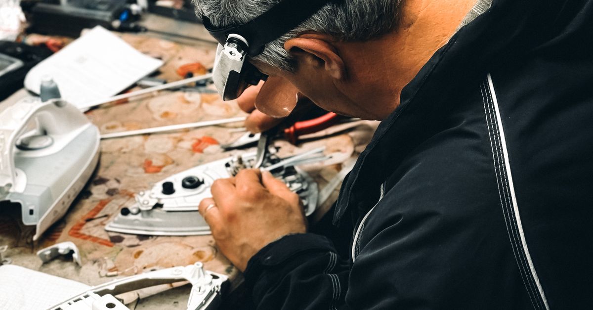 Skilled Technician Repairs Electronics in Workshop · Free Stock Photo