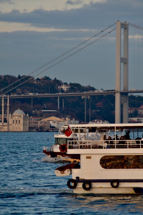 Free Ferry cruising on the Bosphorus with iconic Istanbul bridge in the background. Stock Photo