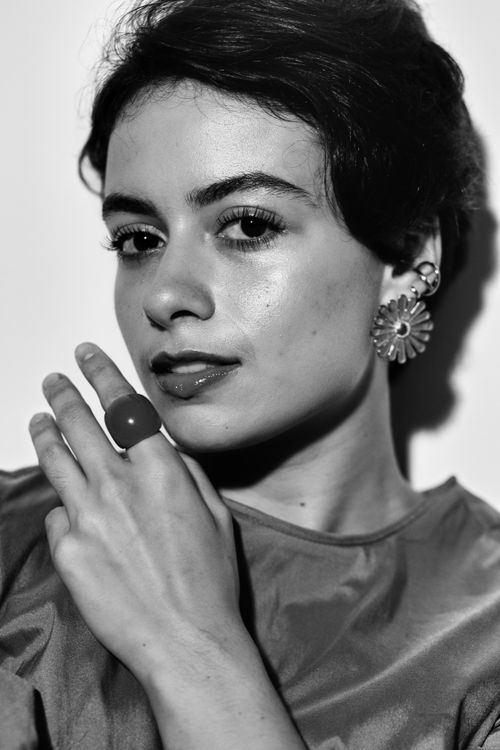 Free Chic black and white portrait of a woman with stylish jewelry and sophisticated demeanor. Stock Photo