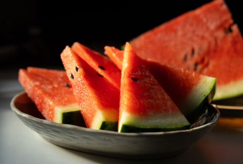 Free Close-up of juicy watermelon slices beautifully arranged in a ceramic bowl, perfect for summer refreshment. Stock Photo