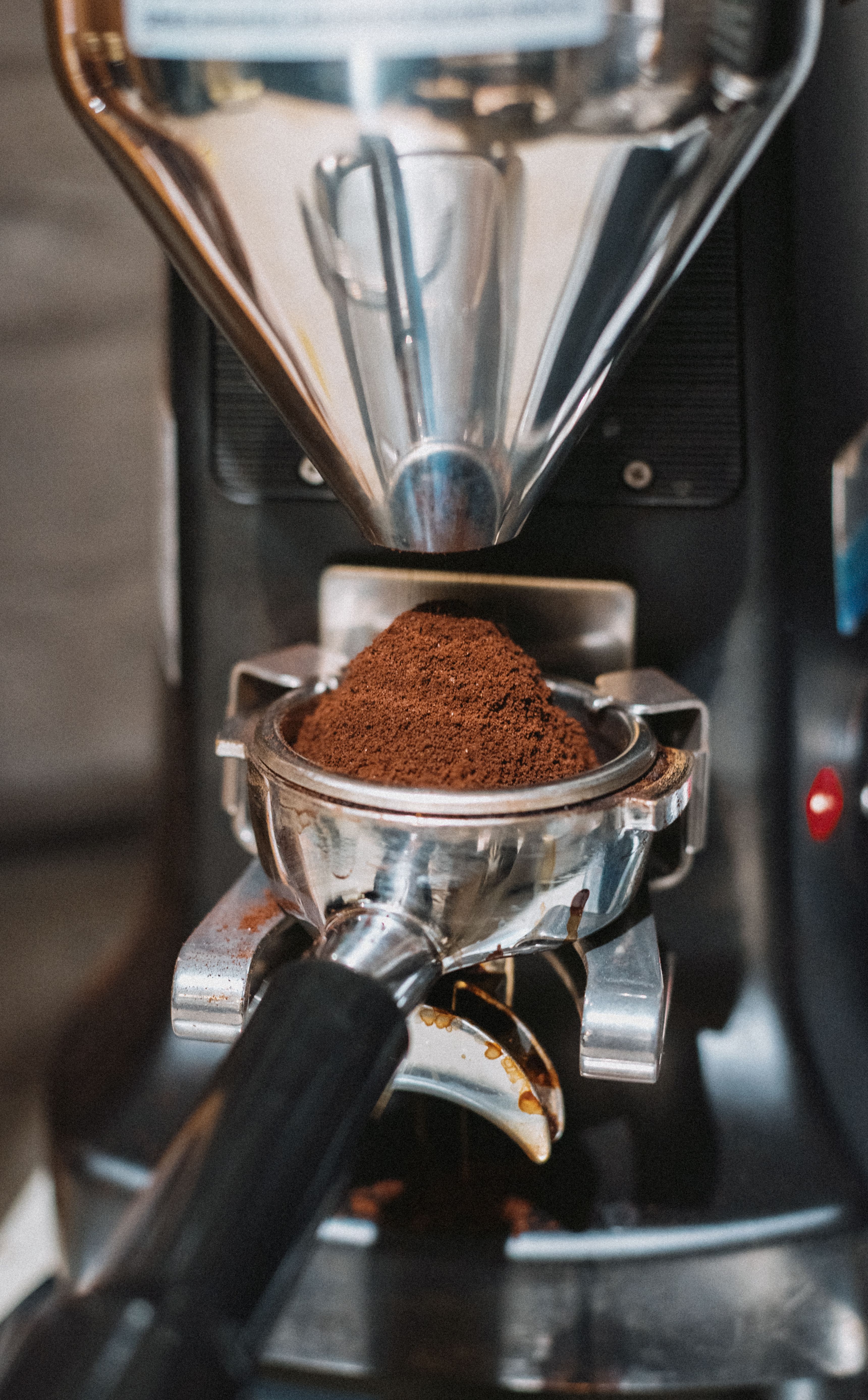 Detailed view of coffee grounds being prepared in a professional espresso machine in Shinjuku, Tokyo, Japan.