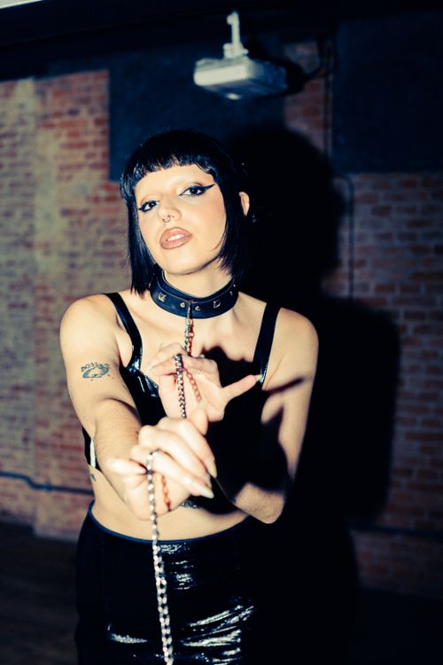 Free Portrait of a woman with dark makeup in a São Paulo studio, showcasing edgy fashion style. Stock Photo