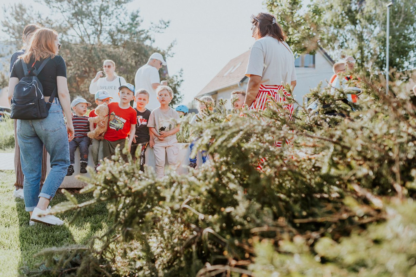 Children and adults taking part in an outdoor community activity together