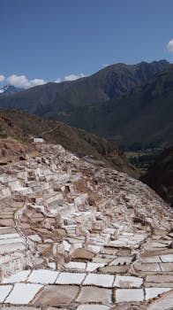 Breathtaking view of salt flats in the Peruvian Andes under clear blue skies.