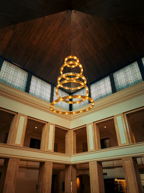 Free Luxurious interior showcasing a modern geometric chandelier in a well-designed space. Stock Photo