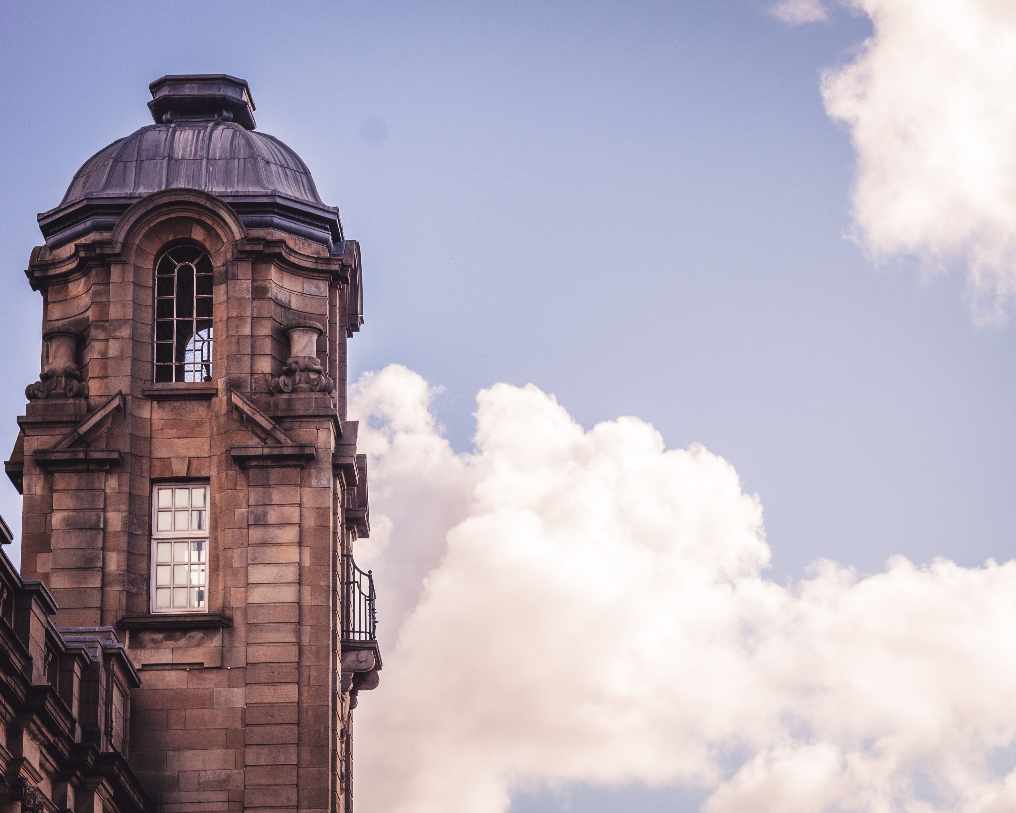 Historic Stone Tower against Blue Sky with Clouds · Free Stock Photo