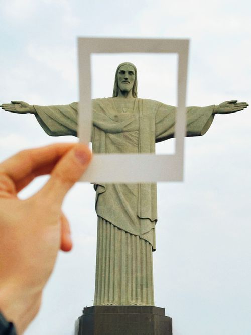 Free Hand framing the Christ the Redeemer statue in Rio de Janeiro, Brazil, creatively. Stock Photo