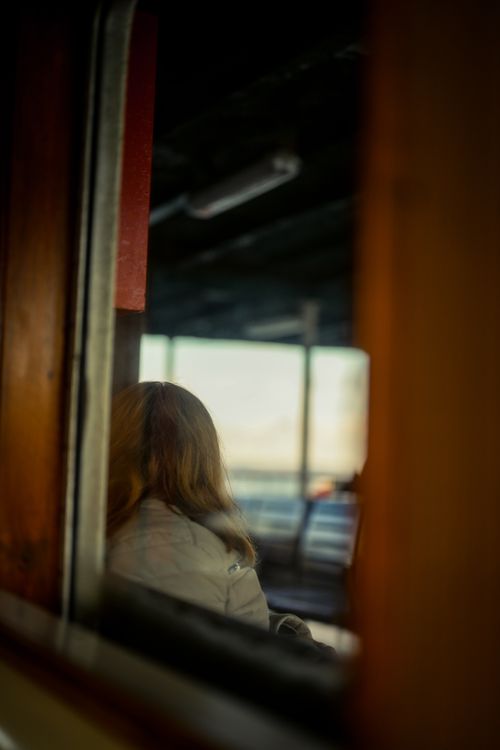 Free Abstract view of a woman reflected in a bus window, creating a contemplative atmosphere. Stock Photo