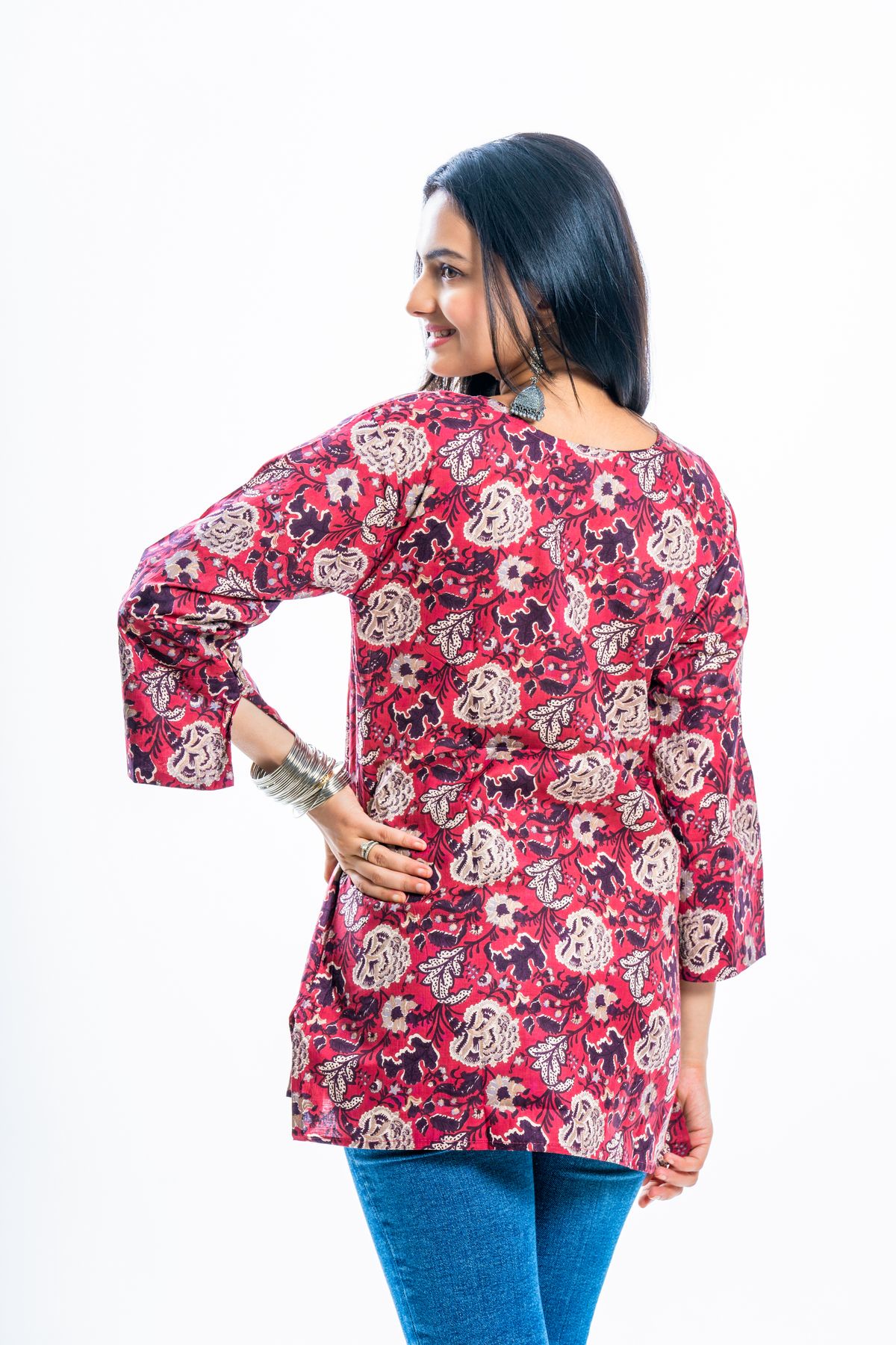 Vibrant floral tunic photographed to show the drape and hem length of a tunic top Vibrant floral tunic photographed to show the drape and hem length of a tunic top