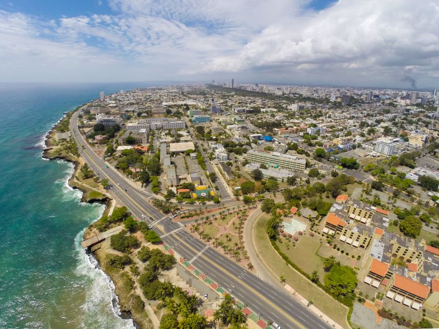 Stunning aerial view of Santo Domingo's coastline alongside the cityscape, capturing the vibrant urban layout and vibrant ocean.