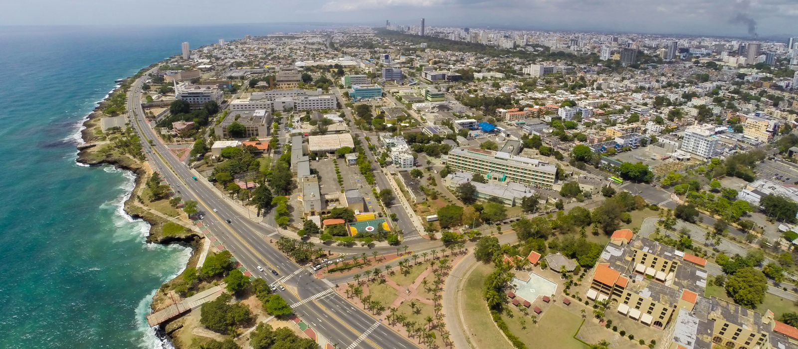 Stunning aerial view of Santo Domingo's coastline alongside the cityscape, capturing the vibrant urban layout and vibrant ocean. — flights from San Juan to Santo Domingo