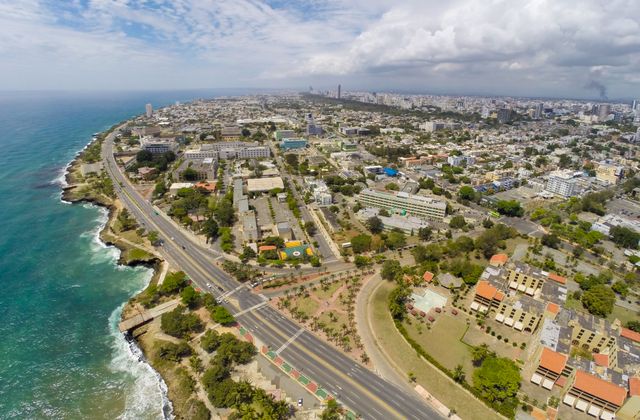 Stunning aerial view of Santo Domingo's coastline alongside the cityscape, capturing the vibrant urban layout and vibrant ocean. — arriving in Santo Domingo