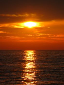 Golden sunset over tranquil ocean, perfect for serene and peaceful themes.