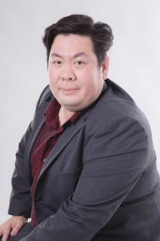 Portrait of an adult man in a suit with a neutral background. Ideal for business and corporate settings.