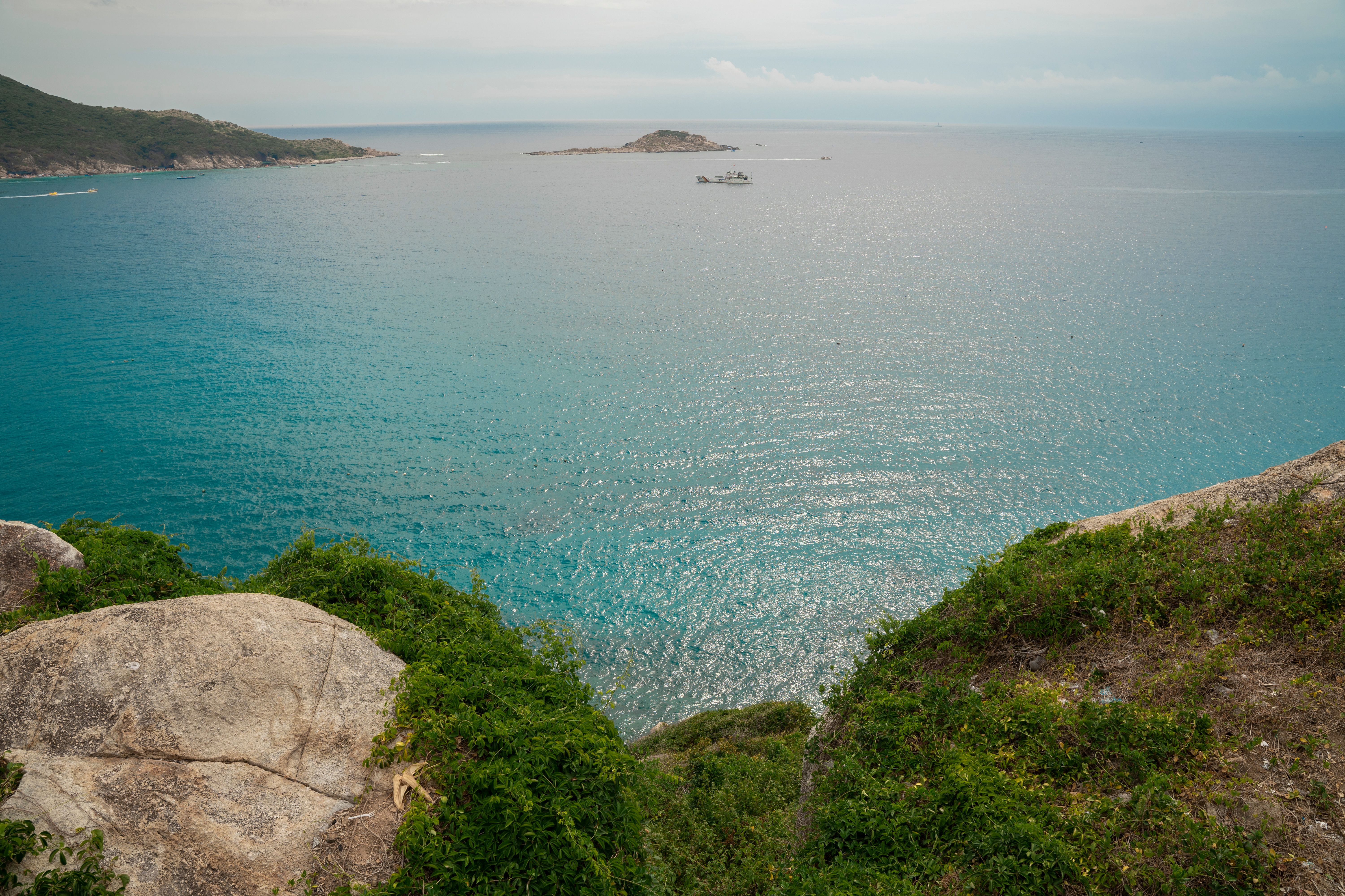 Scenic Coastal View Overlooking Clear Blue Sea · Free Stock Photo