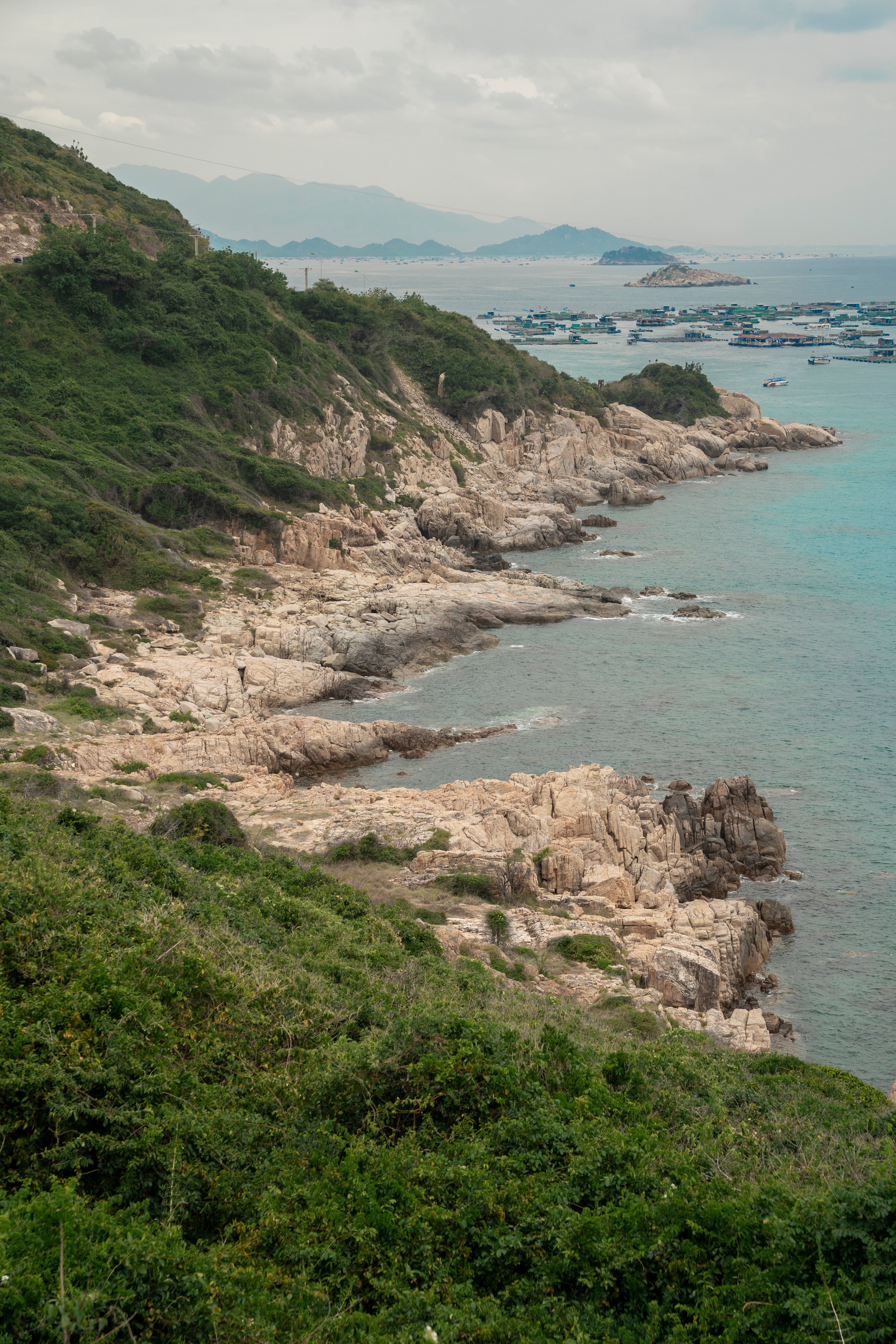Scenic Coastal View with Rocky Shoreline and Greenery · Free Stock Photo