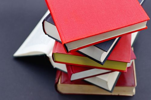 A stack of hardcover books — photo by Marta Branco on Pexels
