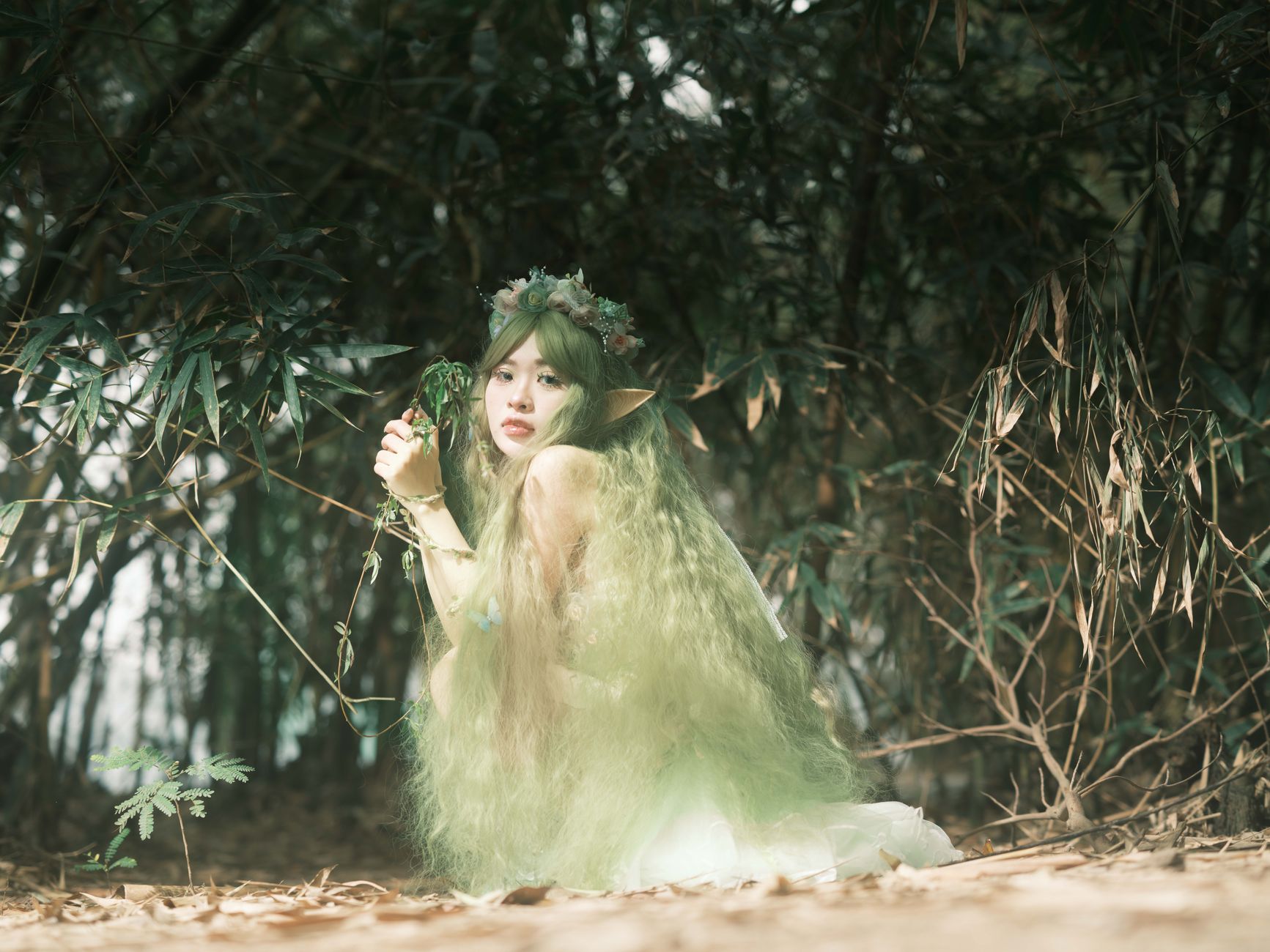 Enchanted elf with long green hair in a magical forest setting, evoking fantasy and whimsy.