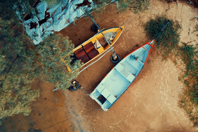 Two Empty Wooden Boats On Sand