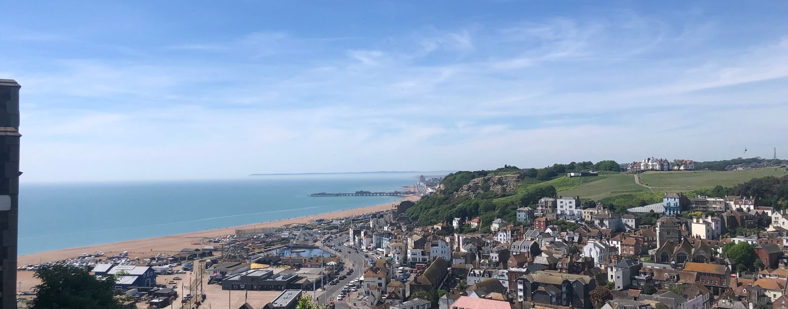 Sunny aerial view over Hastings with coastline and historical buildings in the UK.