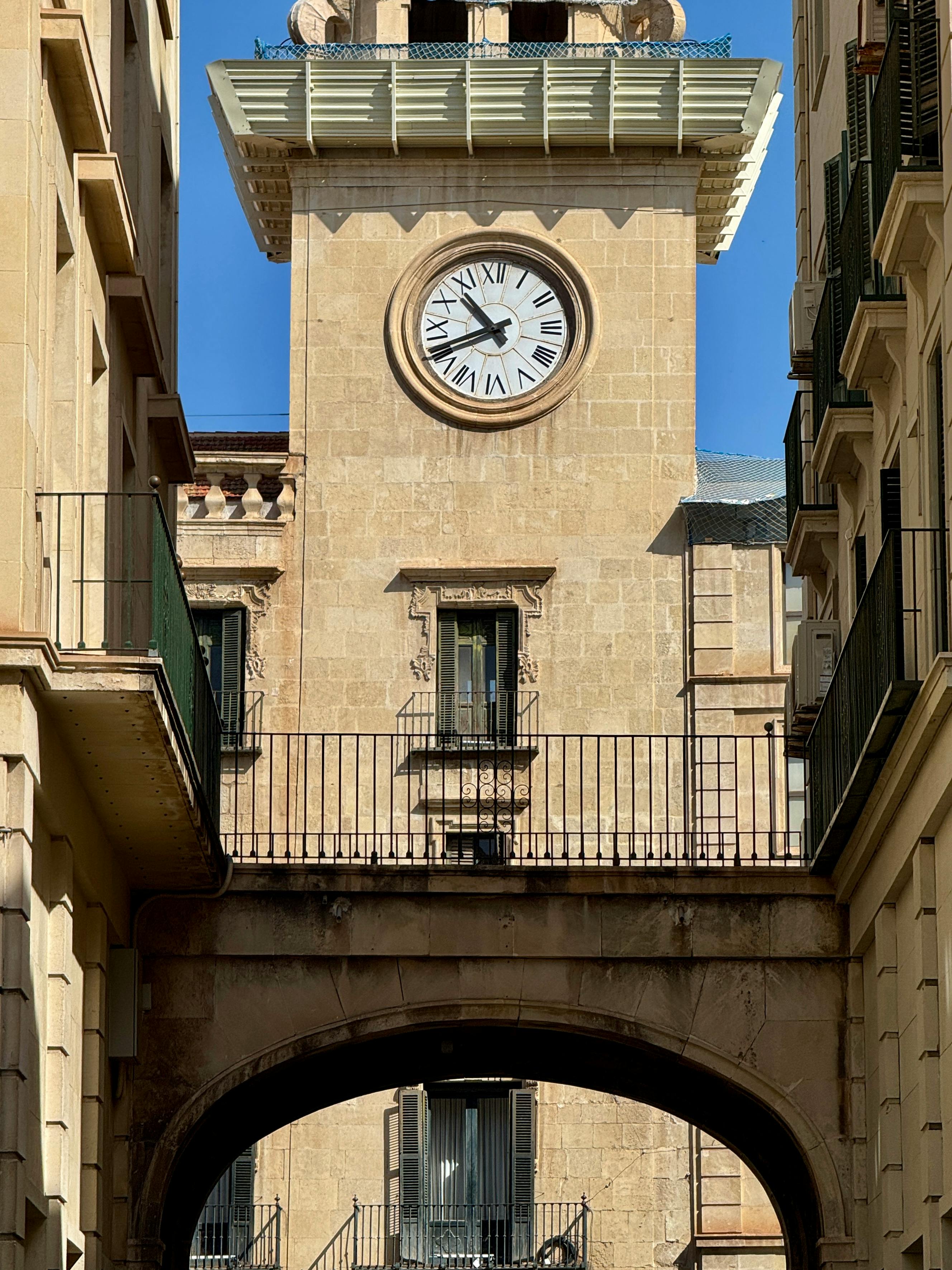 View of the historic clock tower in Alicante, showcasing classic Mediterranean architecture.