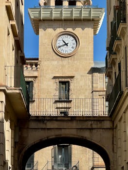 View of the historic clock tower in Alicante, showcasing classic Mediterranean architecture.