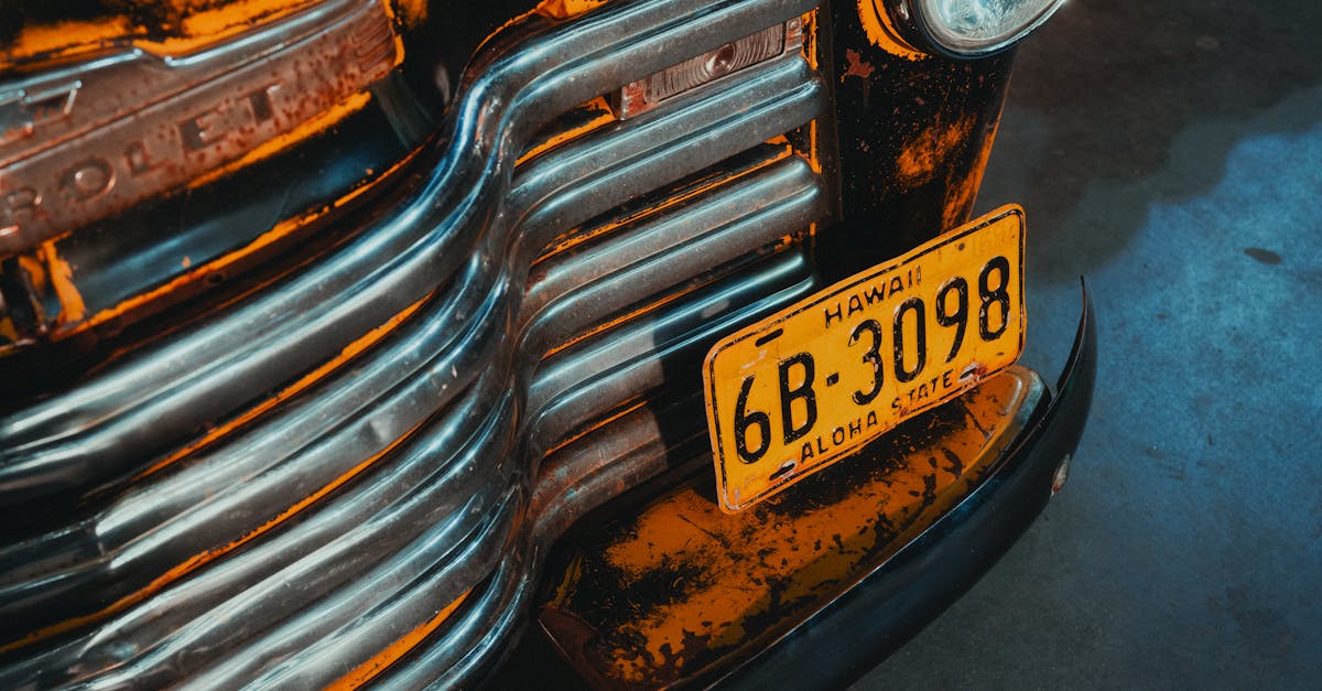 Photo by James Bond Close-up of a vintage yellow car showcasing its unique design and Hawaii license plate.
