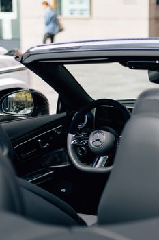 Close-up view of a sleek and stylish convertible car interior, showcasing luxury and modern design elements.