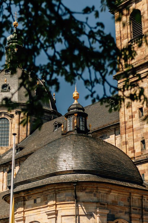 Free Close-up of a historic church dome with golden elements against a clear sky. Stock Photo