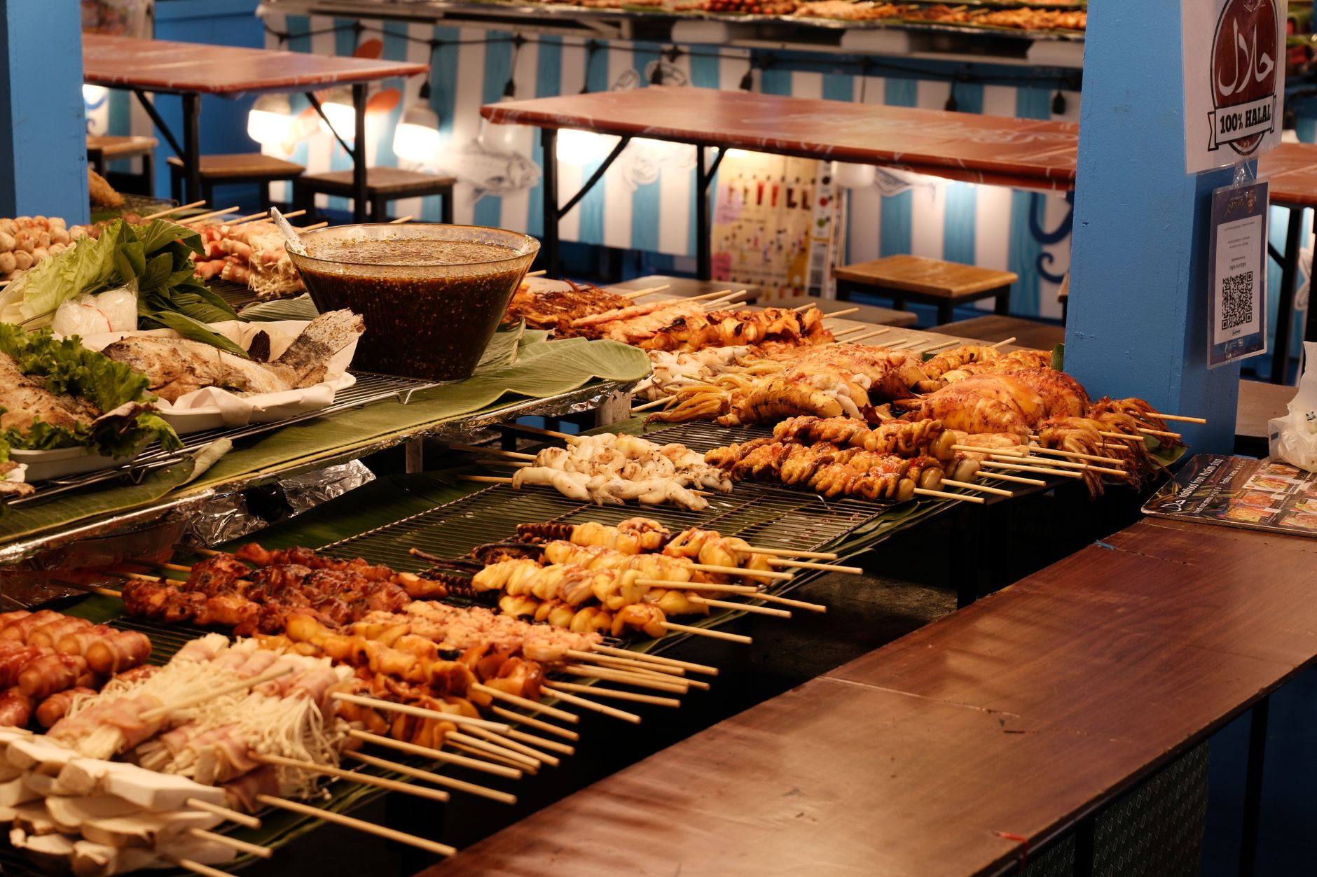 Vibrant street food market showcasing a variety of grilled skewers, a feast for the eyes and taste buds.