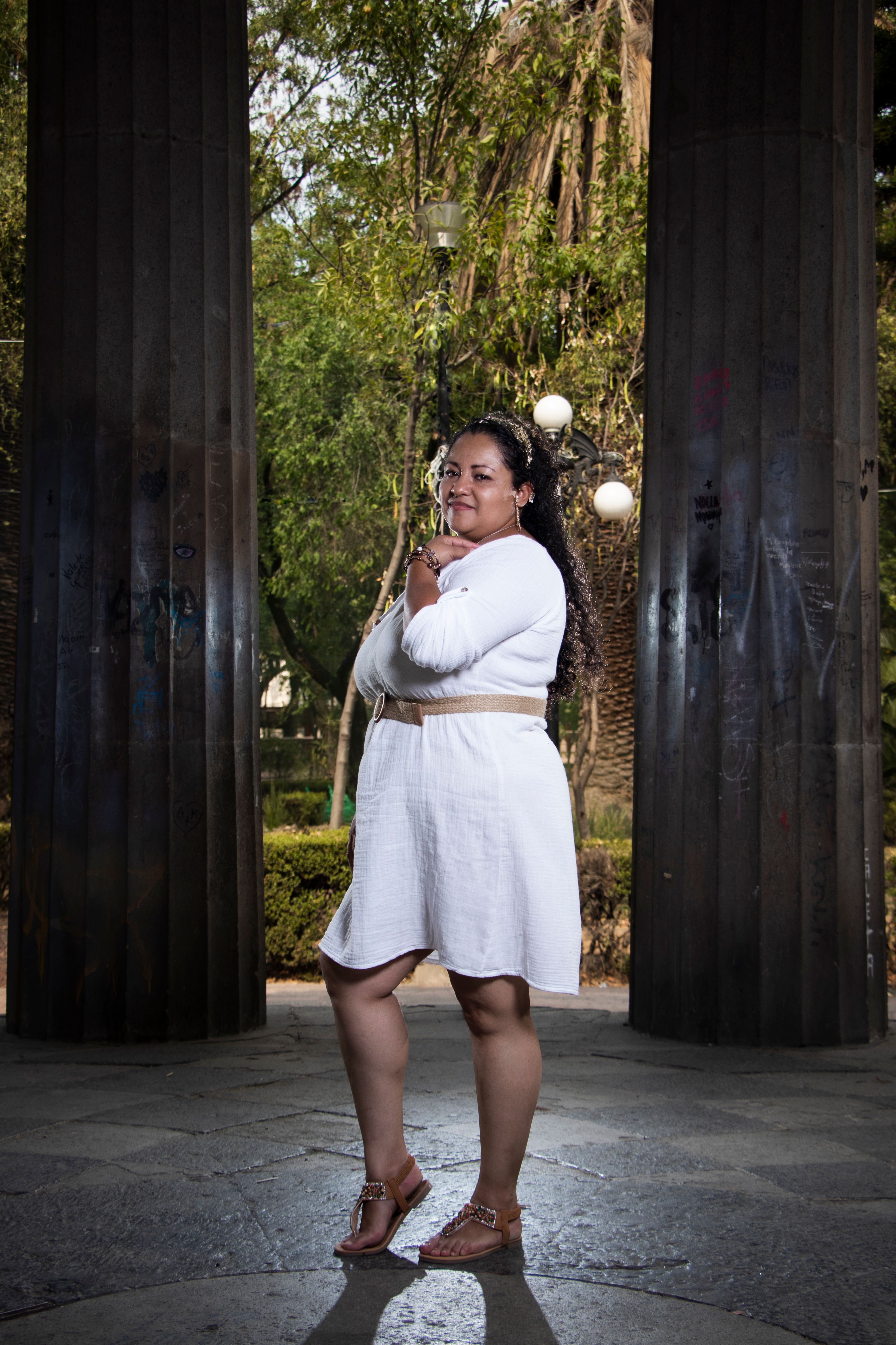 Confident Woman Posing in Urban Park Setting · Free Stock Photo