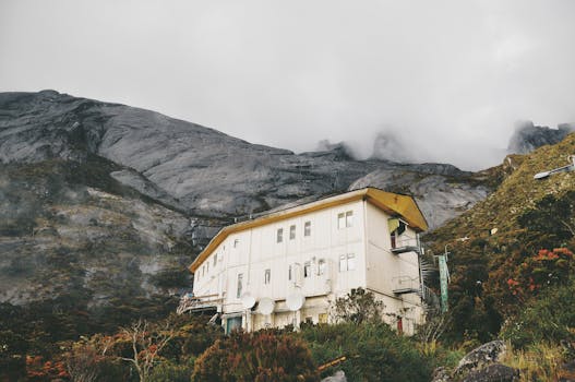 Serene mountain lodge nestled against the backdrop of misty peaks in Ranau, Sabah.