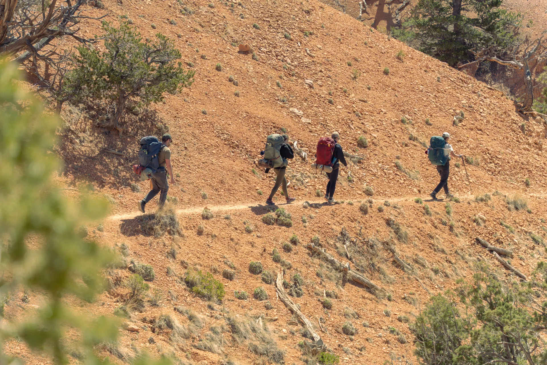 Group of hikers with backpacks navigating the rugged desert landscape of Bryce Canyon, Utah. Group of hikers with backpacks navigating the rugged desert landscape of Bryce Canyon, Utah.