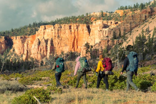 Group of hikers trekking through Bryce Canyon National Park, Utah, with vibrant red rock formations.