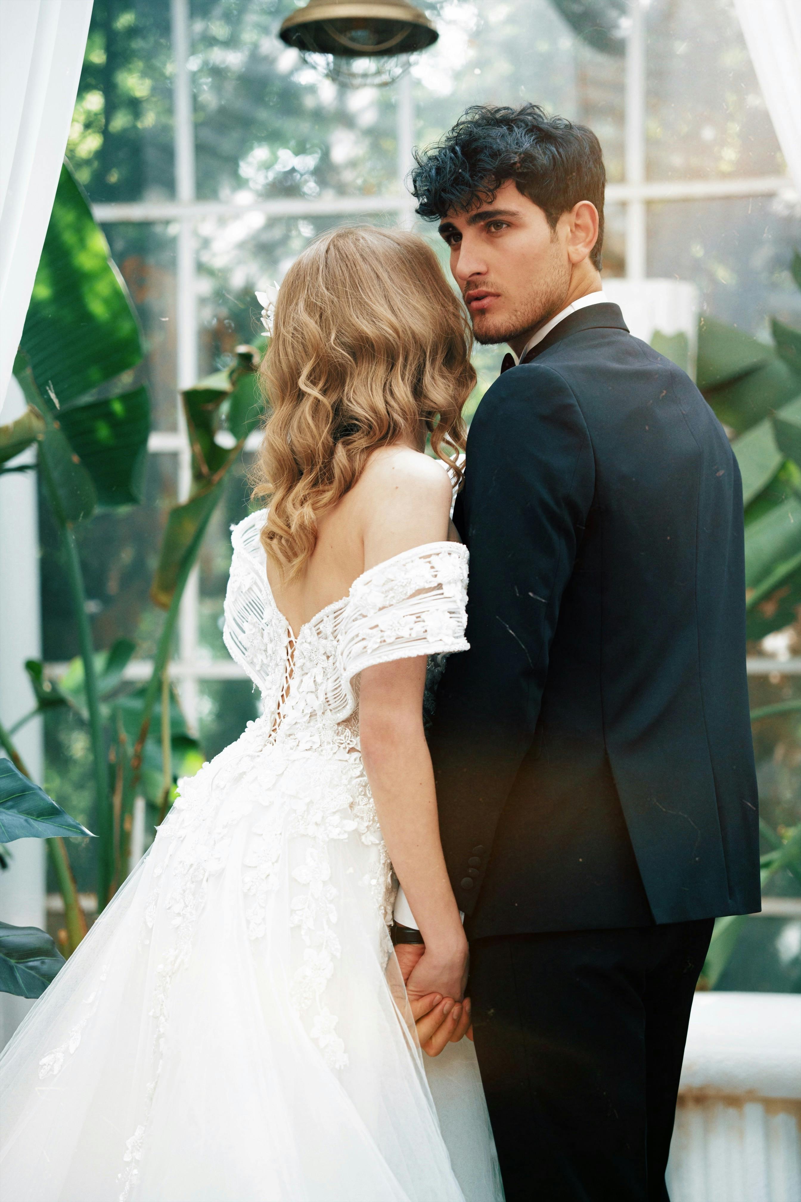 Artistic wedding portrait with dramatic floral background