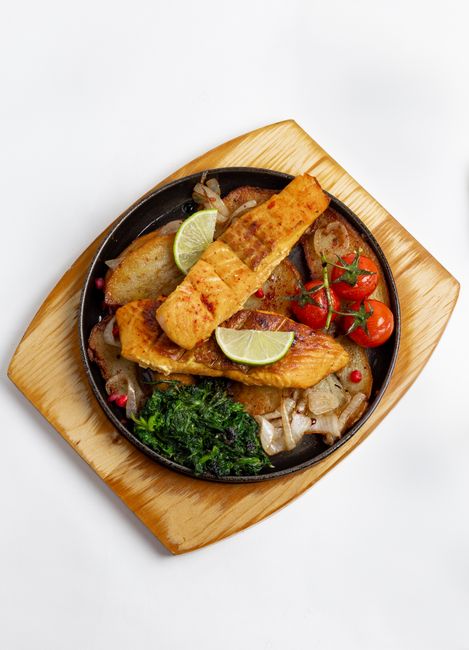 grilled salmon plated with vegetables