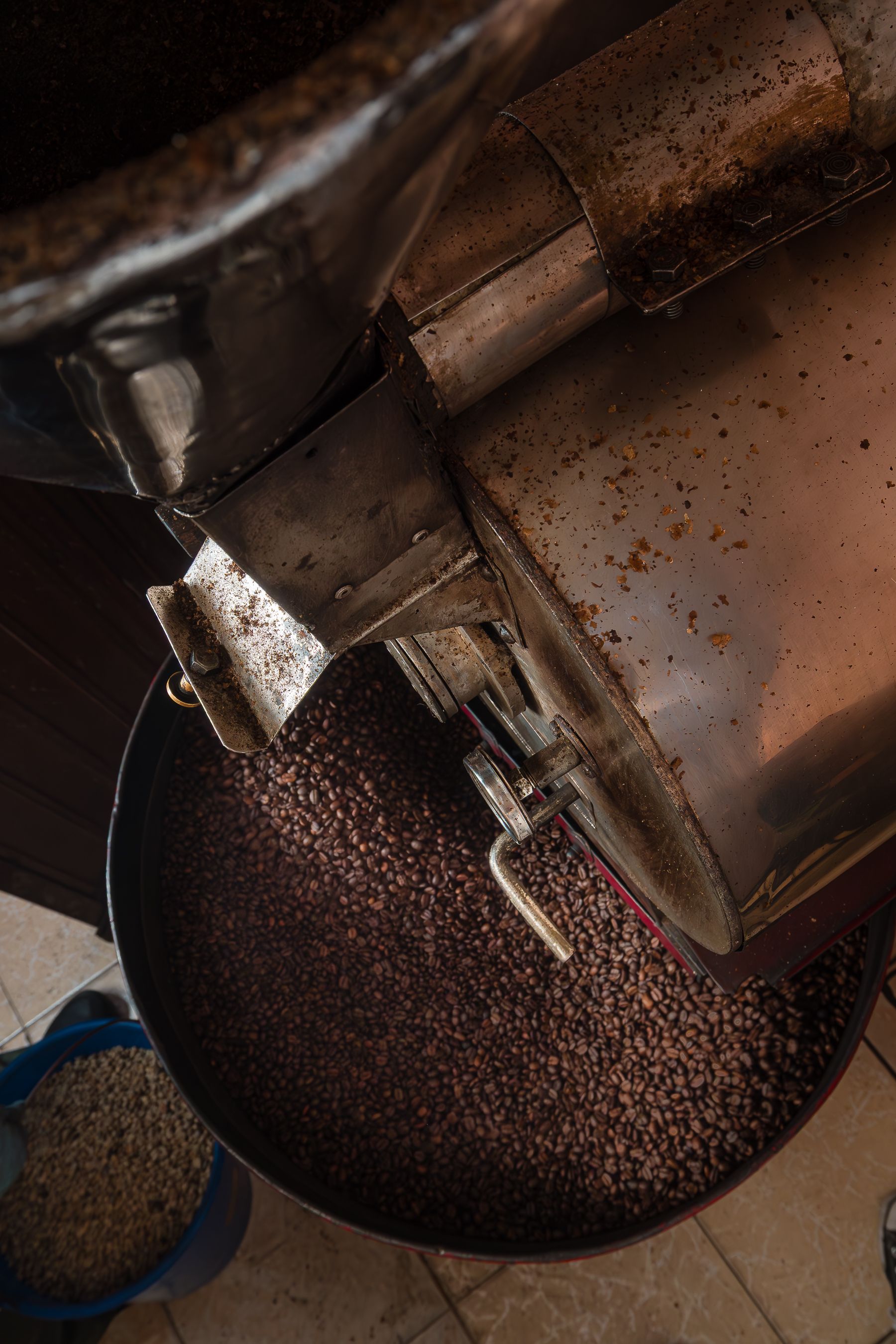 Top view of a coffee roasting machine with freshly roasted beans, ideal for coffee enthusiasts.