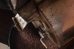 Top view of a coffee roasting machine with freshly roasted beans, ideal for coffee enthusiasts.