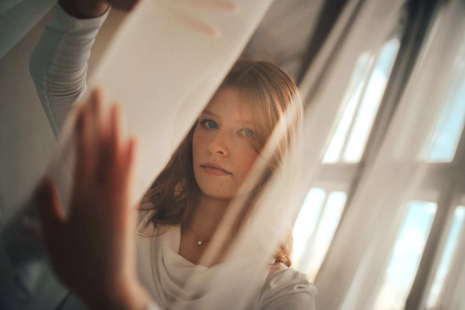 Instructor Mara Solis lit by soft window light behind sheer curtains — photo by Svenja Gross on Pexels