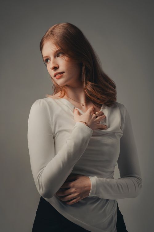 Free A serene portrait of a young woman indoors with thoughtful expression. Stock Photo
