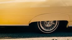 Vintage Yellow Car with Spoke Wheel