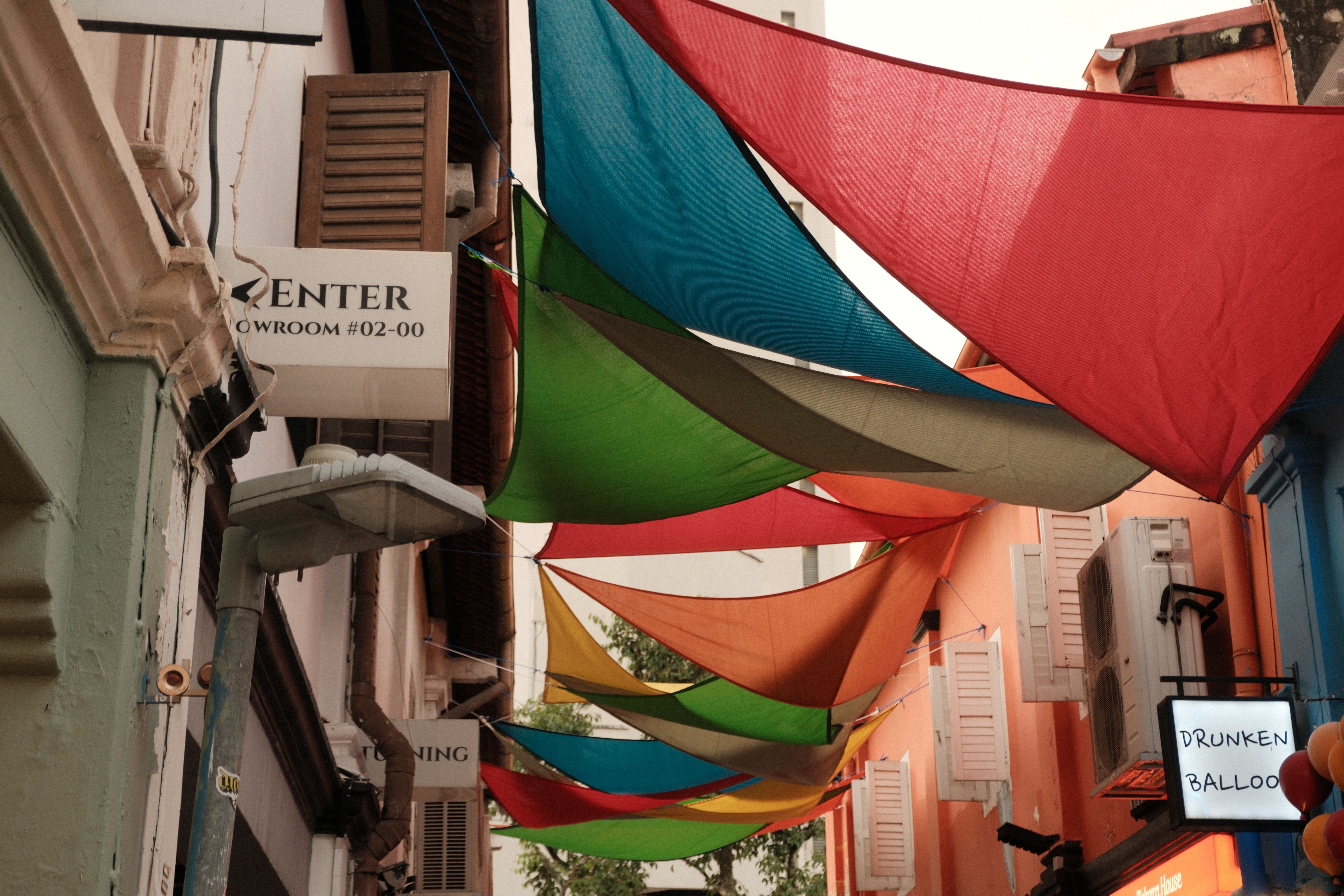 Vibrant colored canopies over a Singapore street, creating an artistic and lively atmosphere. - Photo by Jeremy Rubio on Pexels