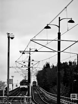 Monochrome image of a tram on Istanbul railway line, showcasing urban infrastructure.