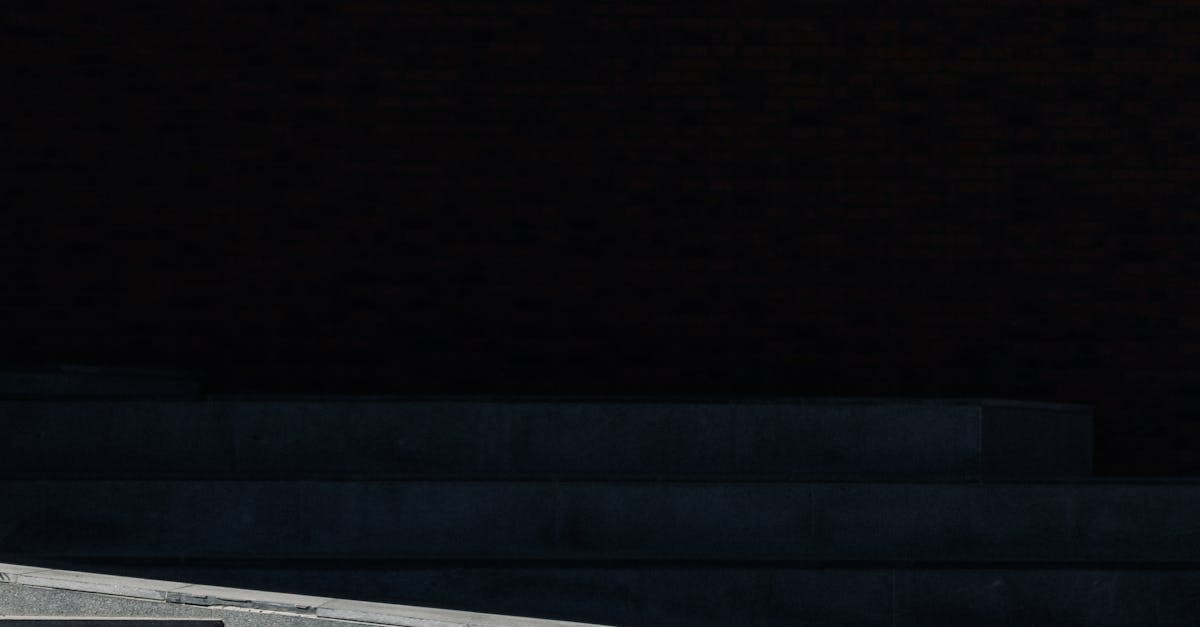 A gravel bike with gear parked on urban concrete steps, casting a shadow.