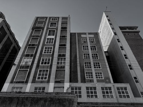 Free Monochrome urban scene featuring tall buildings under a clear sky. Stock Photo