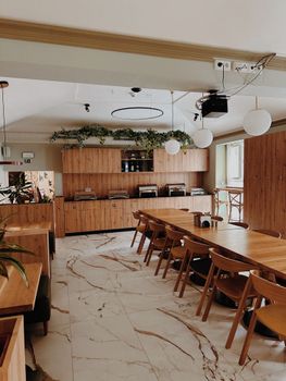 Contemporary café interior featuring wooden furniture and elegant marble flooring.