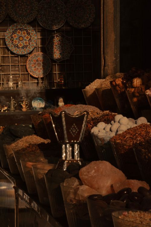 Free A captivating view of a spice stall with traditional ceramics and spices in Dubai's market. Stock Photo