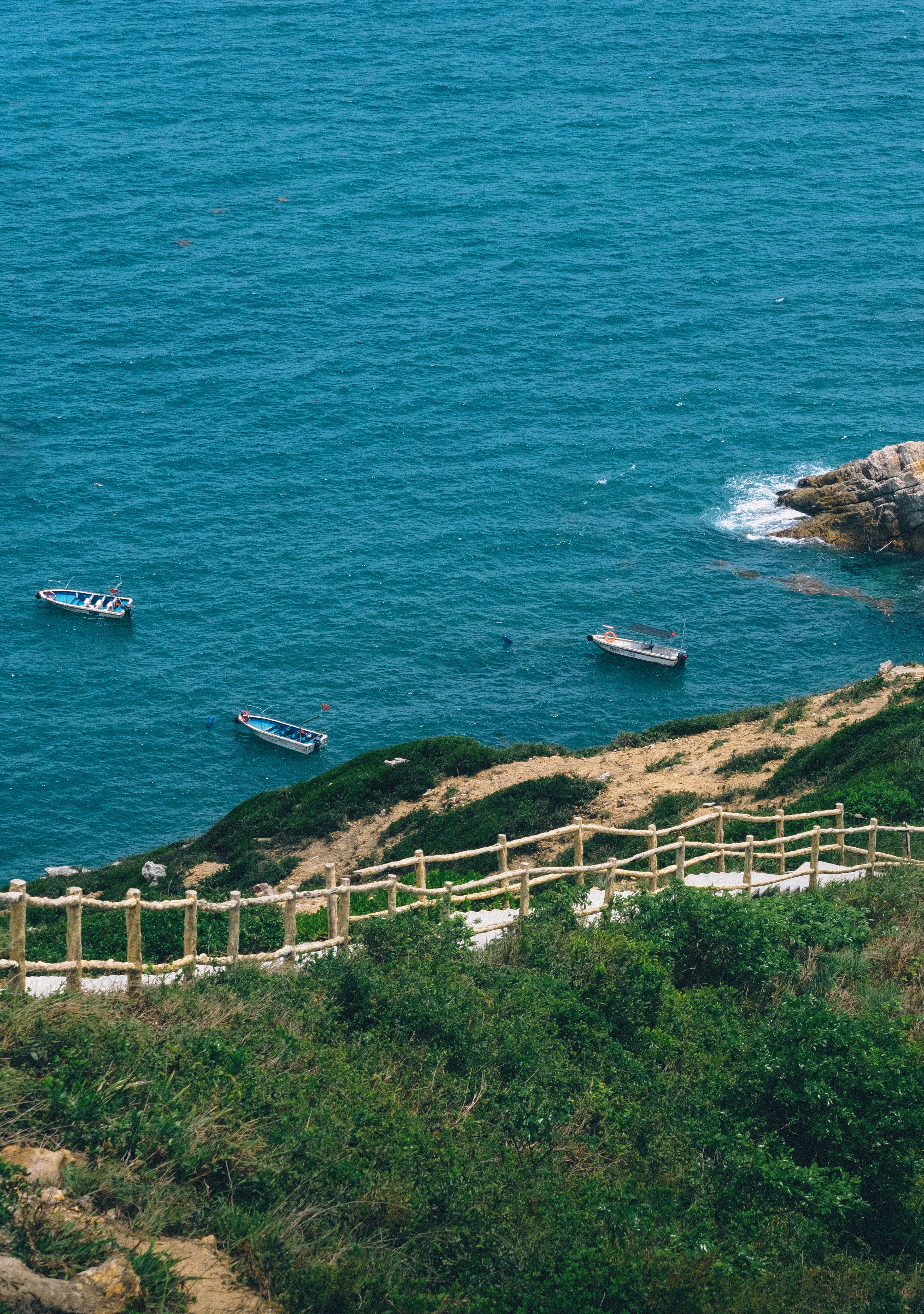 Scenic Coastal View with Blue Ocean and Boats